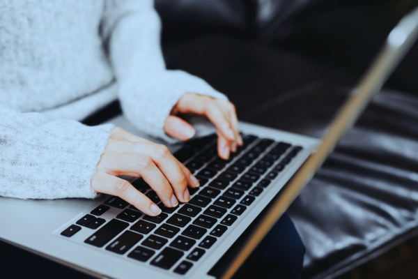 Woman Typing on Laptop Closeup